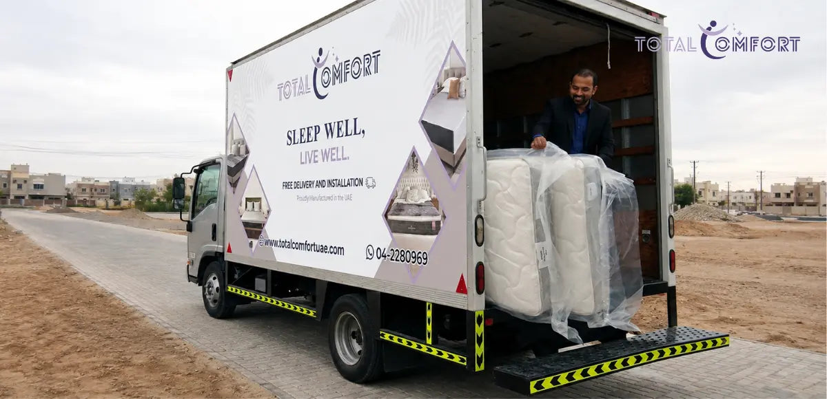 Mattress delivery truck unloading a mattress at a customer’s location in the UAE.